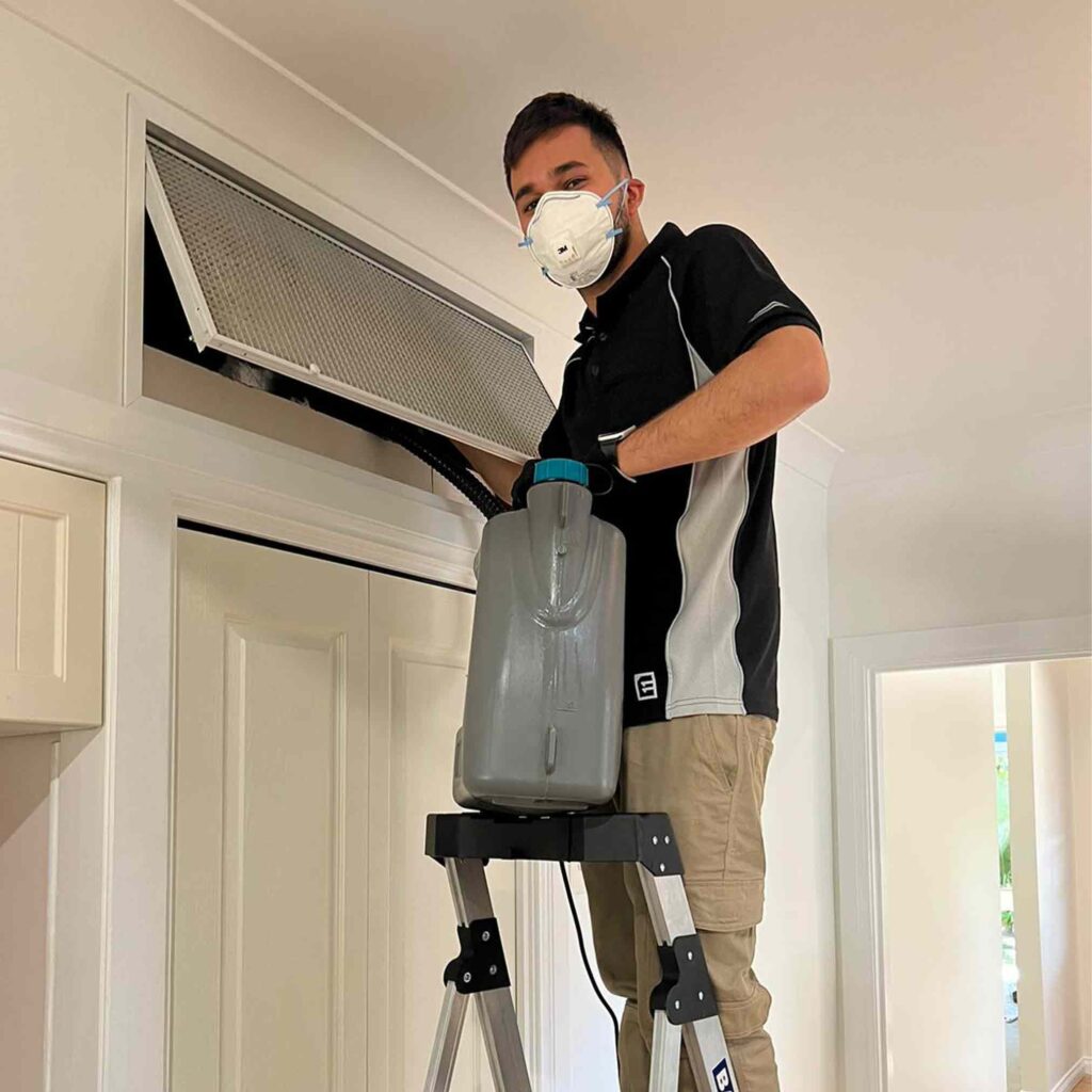 Air duct technician doing Sanitation Disinfection